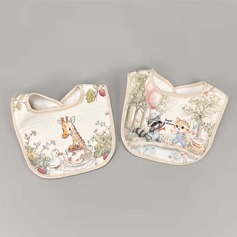 Two baby bibs with animal-themed designs on a gray background