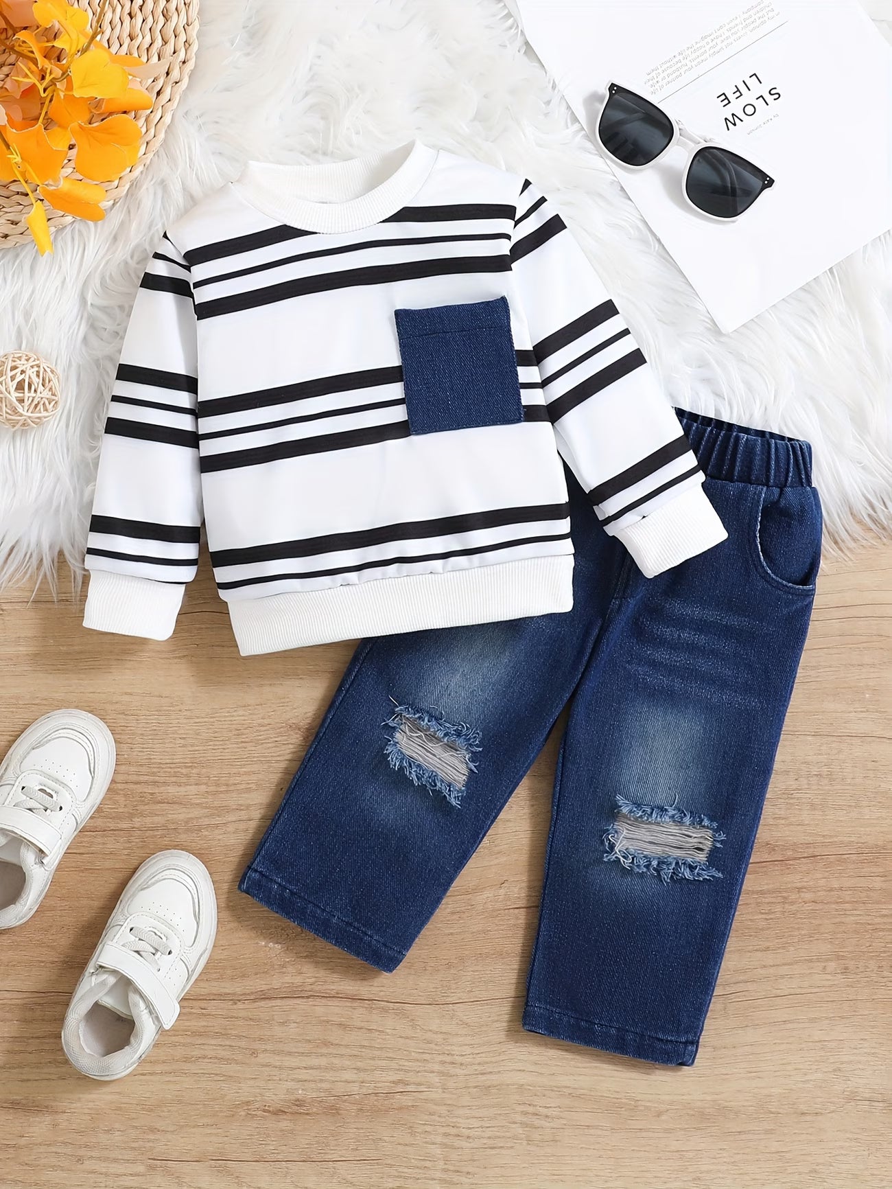 Children's outfit with striped sweater and ripped jeans