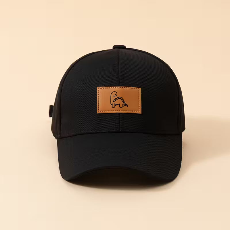 Black cap with a brown leather patch on a beige background